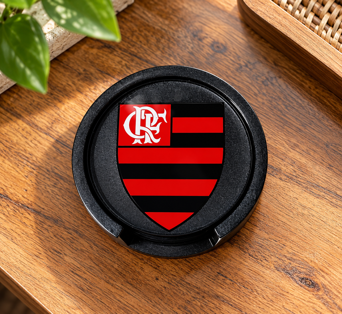 Close-up of a black coaster with a red-and-black Flamengo crest