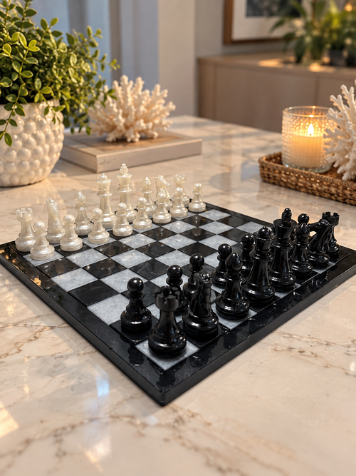 Glossy black and white chessboard with black and white chess pieces