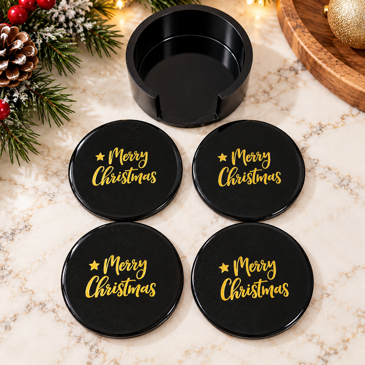 Four black Christmas coasters with gold-colored Merry Christmas lettering and matching black holder