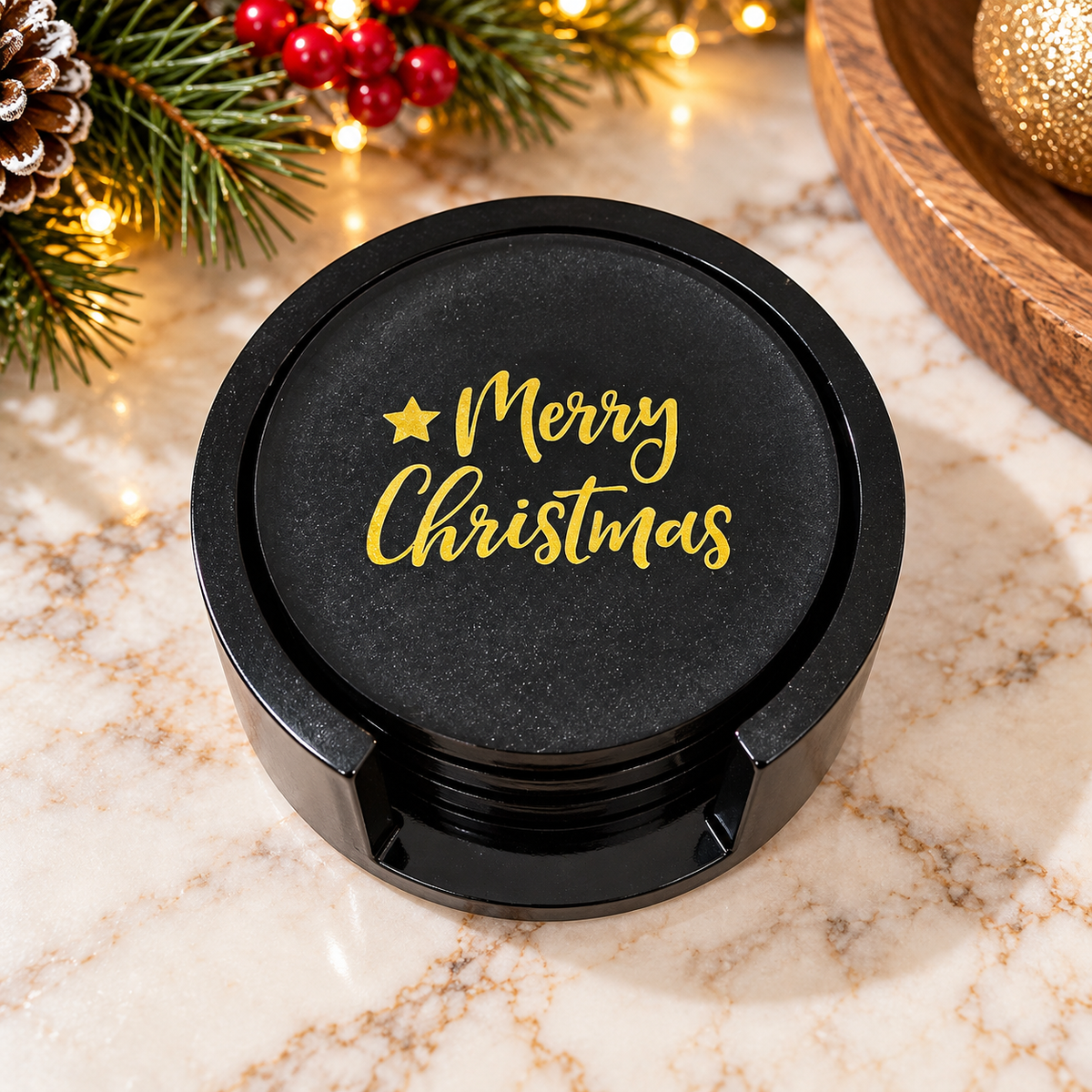Christmas coasters stacked in a black holder with gold-colored Merry Christmas lettering