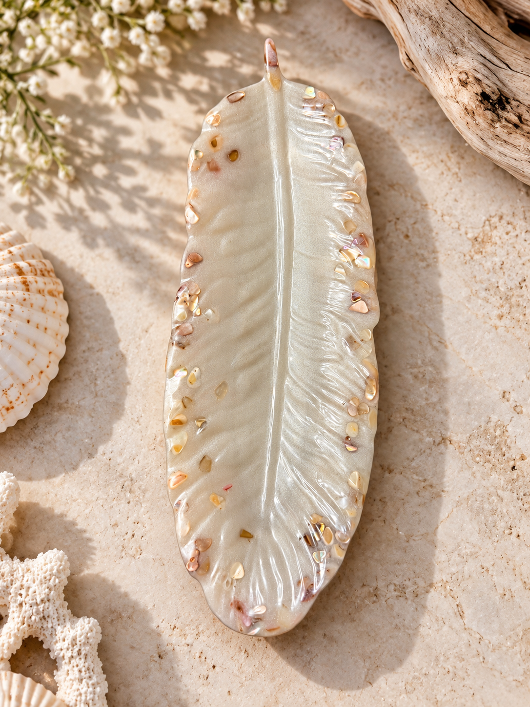 White feather-shaped jewelry holder with shell accents