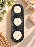 Black elongated resin holder with three included candles